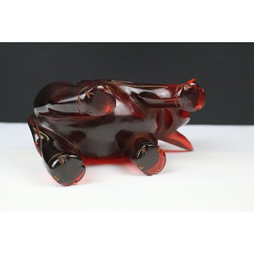 312 - An ornamental figure of an oriental gentleman in traditional dress together with an amber coloured o... 