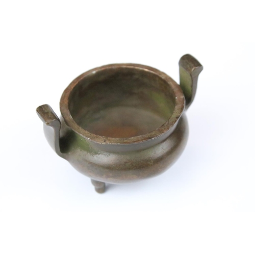 318 - A small Chinese bronze pot / sensor with character marks to base.