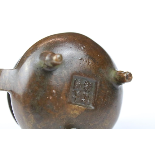 318 - A small Chinese bronze pot / sensor with character marks to base.