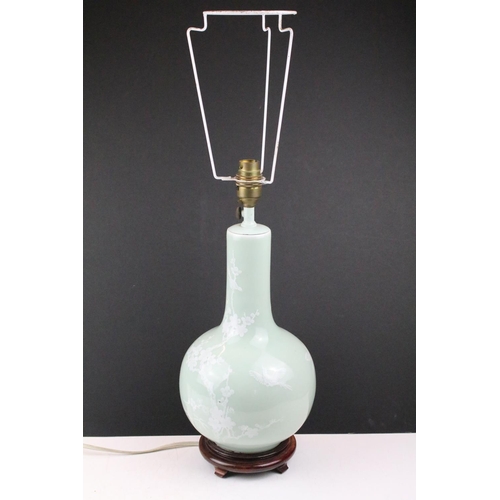 91 - Celadon glazed table lamp decorated with birds and blossoming branched, raised on a hardwood base. (... 