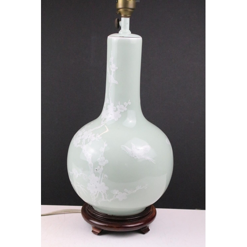 91 - Celadon glazed table lamp decorated with birds and blossoming branched, raised on a hardwood base. (... 