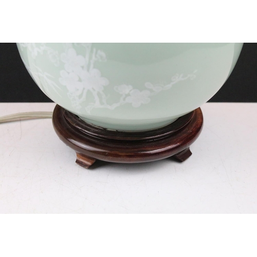 91 - Celadon glazed table lamp decorated with birds and blossoming branched, raised on a hardwood base. (... 