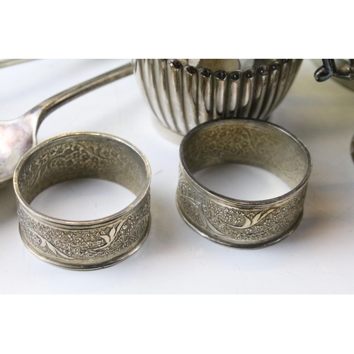 463 - Collection of silver plate to include a set of goblets with moulded stems, napkin rings, taste vin, ... 