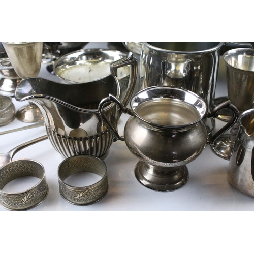 463 - Collection of silver plate to include a set of goblets with moulded stems, napkin rings, taste vin, ... 