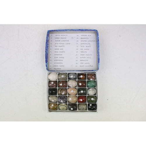 470 - A collection of 100 semi precious stone carved sample eggs housed within four boxes, together with a... 