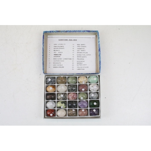 470 - A collection of 100 semi precious stone carved sample eggs housed within four boxes, together with a... 