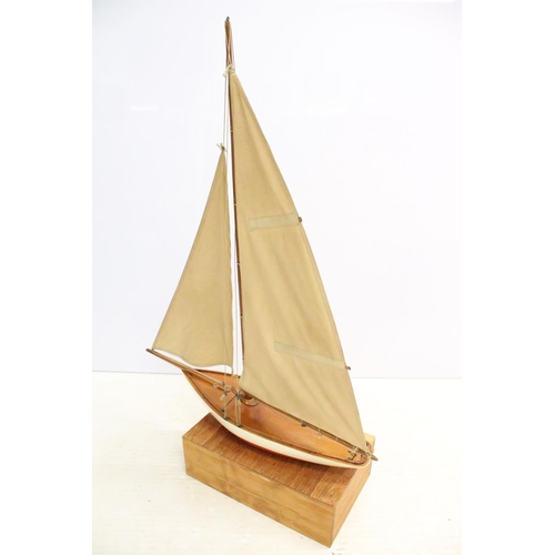 487 - Model sailing boat / pond yacht, with fitted wooden stand, 89cm high