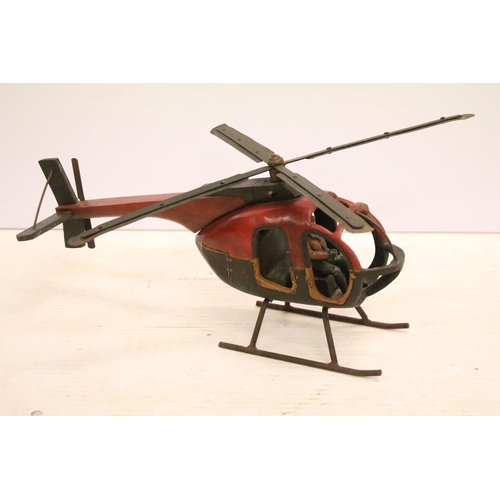 502 - Painted wooden helicopter with metal propellors, complete with pilot, approx 70cm long