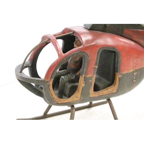 502 - Painted wooden helicopter with metal propellors, complete with pilot, approx 70cm long