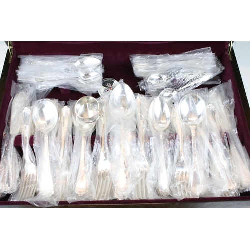 513 - K. Bright of Sheffield - An eight setting canteen of silver plated cutlery, together with a silver h... 