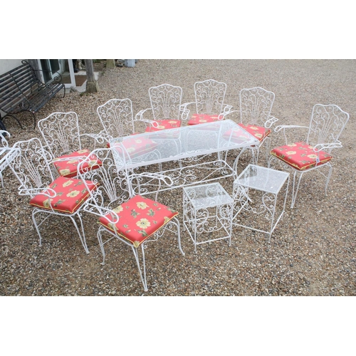 518 - White painted metal patio table set comprising a glass topped table with eight chairs and two glass ... 