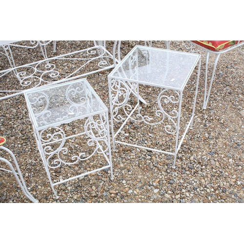 518 - White painted metal patio table set comprising a glass topped table with eight chairs and two glass ... 