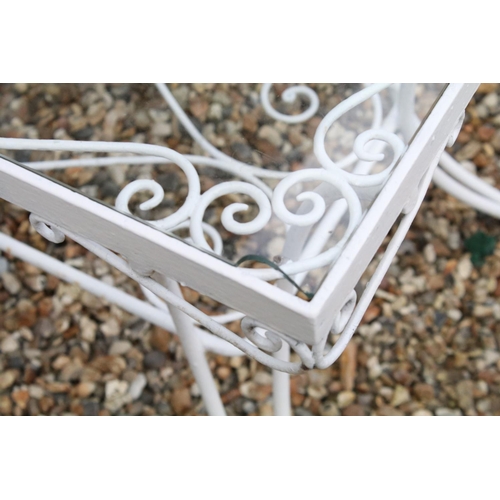 518 - White painted metal patio table set comprising a glass topped table with eight chairs and two glass ... 