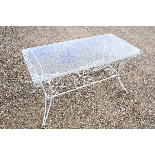 518 - White painted metal patio table set comprising a glass topped table with eight chairs and two glass ... 