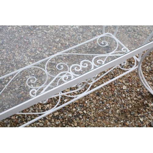 518 - White painted metal patio table set comprising a glass topped table with eight chairs and two glass ... 