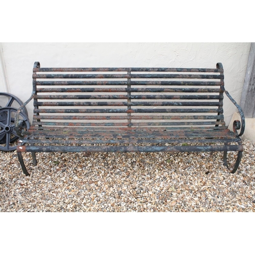 520 - Cast iron slatted garden bench raised on two wrought iron supports of scrolled form, approx 183m W x... 