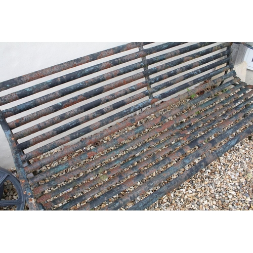 520 - Cast iron slatted garden bench raised on two wrought iron supports of scrolled form, approx 183m W x... 