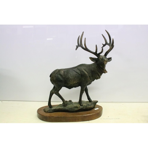 506 - Cast metal model of a stag mounted on a wooden base (approx 45cm high), together with a group of bra... 
