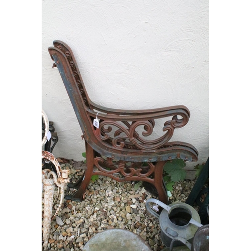 525 - Two pairs of cast iron garden bench supports of scrolled form, tallest approx 81cm