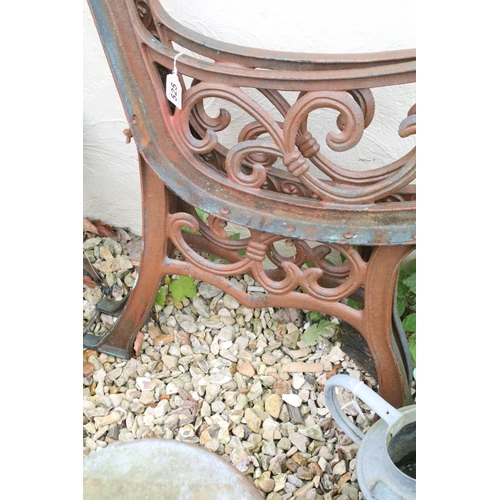 525 - Two pairs of cast iron garden bench supports of scrolled form, tallest approx 81cm