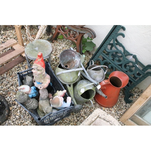 527 - Four metal watering cans together with a jug, metal stall, and a group of garden ornaments to includ... 