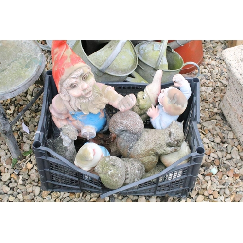 527 - Four metal watering cans together with a jug, metal stall, and a group of garden ornaments to includ... 