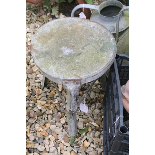 527 - Four metal watering cans together with a jug, metal stall, and a group of garden ornaments to includ... 