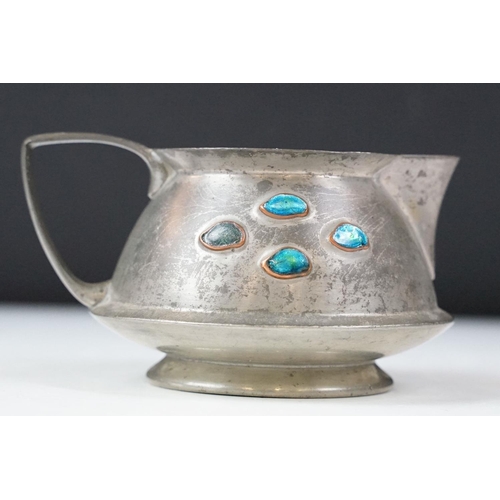 254 - An early twentieth century pewter tea set with peacock enamel decoration in the style of archibald k... 
