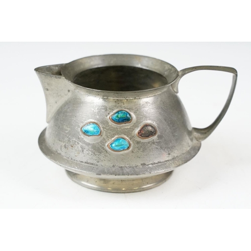 254 - An early twentieth century pewter tea set with peacock enamel decoration in the style of archibald k... 