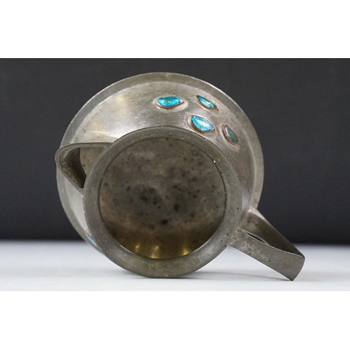 254 - An early twentieth century pewter tea set with peacock enamel decoration in the style of archibald k... 