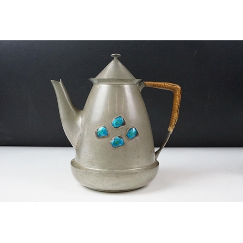 254 - An early twentieth century pewter tea set with peacock enamel decoration in the style of archibald k... 