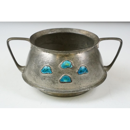 254 - An early twentieth century pewter tea set with peacock enamel decoration in the style of archibald k... 