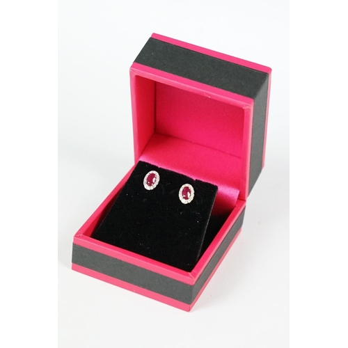 287 - Pair of 18ct white gold ruby and diamond cluster earrings, approx 3/4 carat