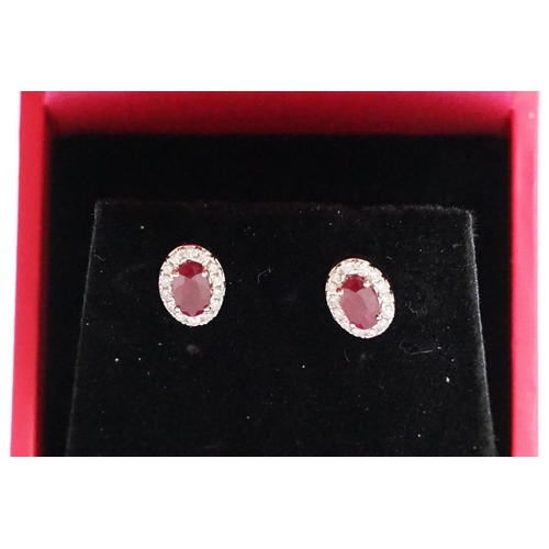 287 - Pair of 18ct white gold ruby and diamond cluster earrings, approx 3/4 carat