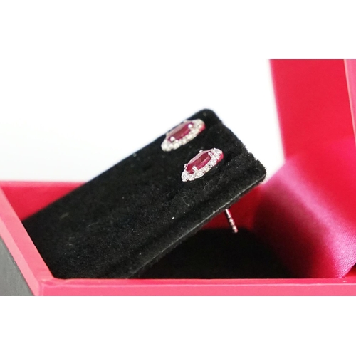 287 - Pair of 18ct white gold ruby and diamond cluster earrings, approx 3/4 carat
