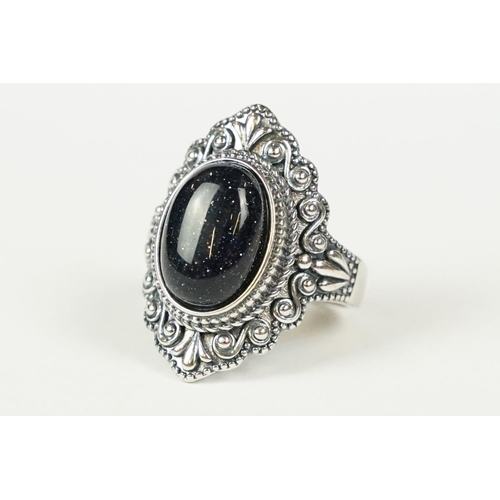 288 - A contemporary 925 sterling silver ring with central cabochon, marked 925 to the verso.