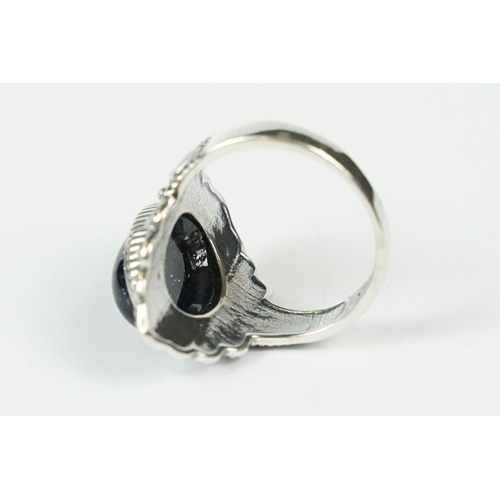 288 - A contemporary 925 sterling silver ring with central cabochon, marked 925 to the verso.
