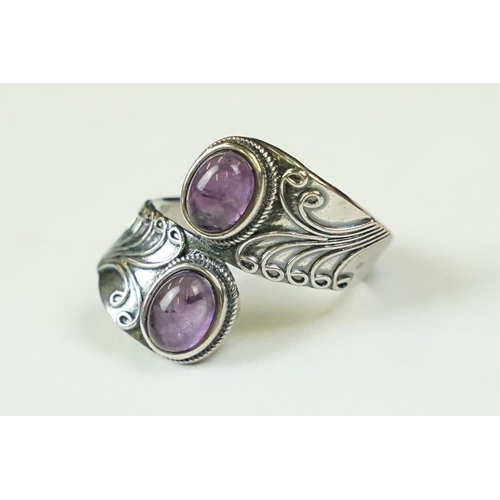 295 - A contemporary 925 sterling silver ring with double amethyst cabochons, marked 925 to the verso.
