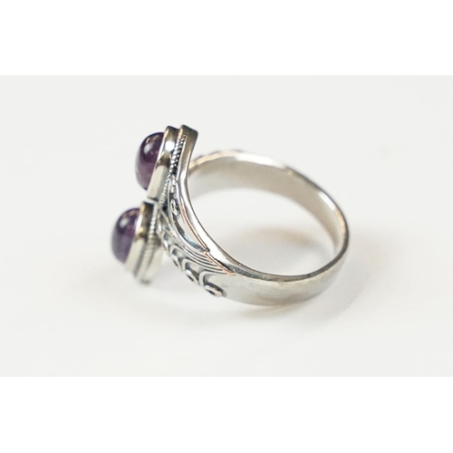 295 - A contemporary 925 sterling silver ring with double amethyst cabochons, marked 925 to the verso.
