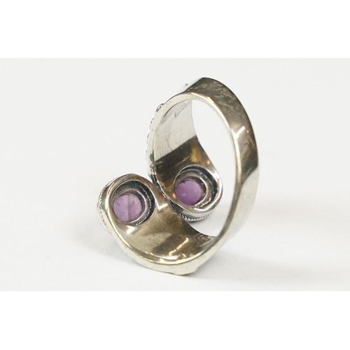 295 - A contemporary 925 sterling silver ring with double amethyst cabochons, marked 925 to the verso.