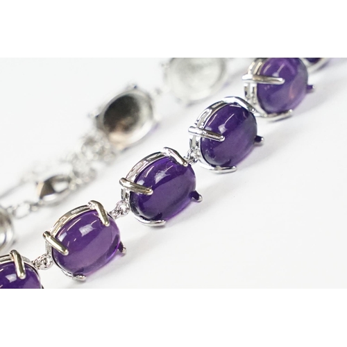 304 - A 925 Sterling Silver and amethyst bracelet, marked 925 to the clasp.