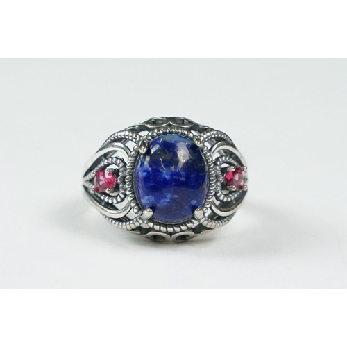 308 - A ladies dress ring set with blue central cabochon, marked 925 to the shank