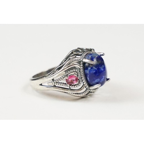 308 - A ladies dress ring set with blue central cabochon, marked 925 to the shank