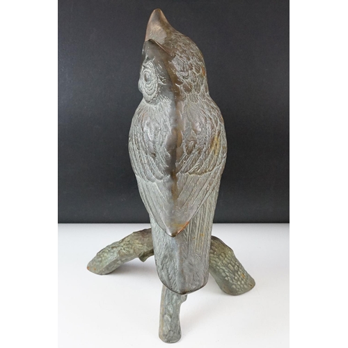 430 - Large metal model of an owl perched on a branch, with verdigris effect finish, approx 48cm high