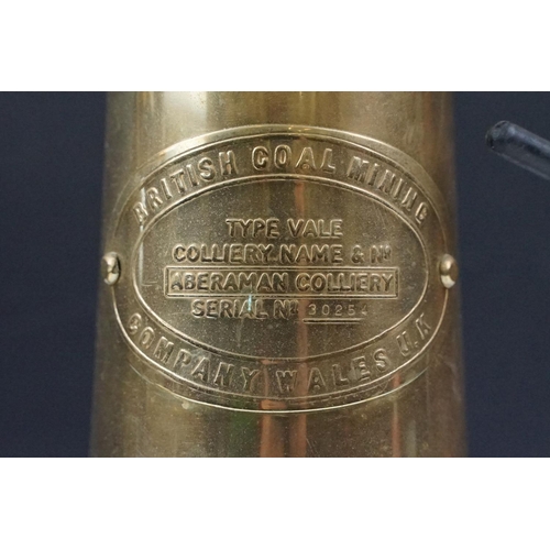 435 - Two 'British Coal Mining' brass miners lamps, together with a pair of barley twist wooden candlestic... 