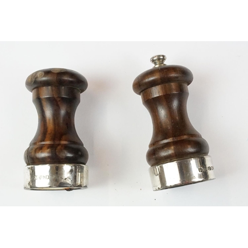 435 - Two 'British Coal Mining' brass miners lamps, together with a pair of barley twist wooden candlestic... 