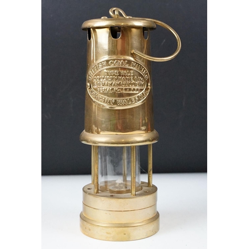 435 - Two 'British Coal Mining' brass miners lamps, together with a pair of barley twist wooden candlestic... 