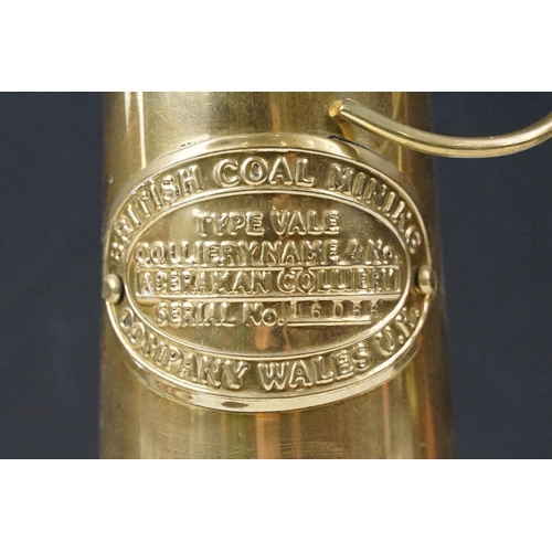 435 - Two 'British Coal Mining' brass miners lamps, together with a pair of barley twist wooden candlestic... 