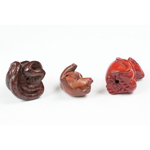 202 - A collection of three carved oriental Netsuke in the form of animals.