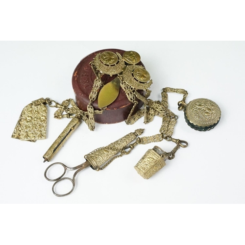 208 - An antique brass Chatelaine complete with pencil, pin cushion, scissors and thimble.